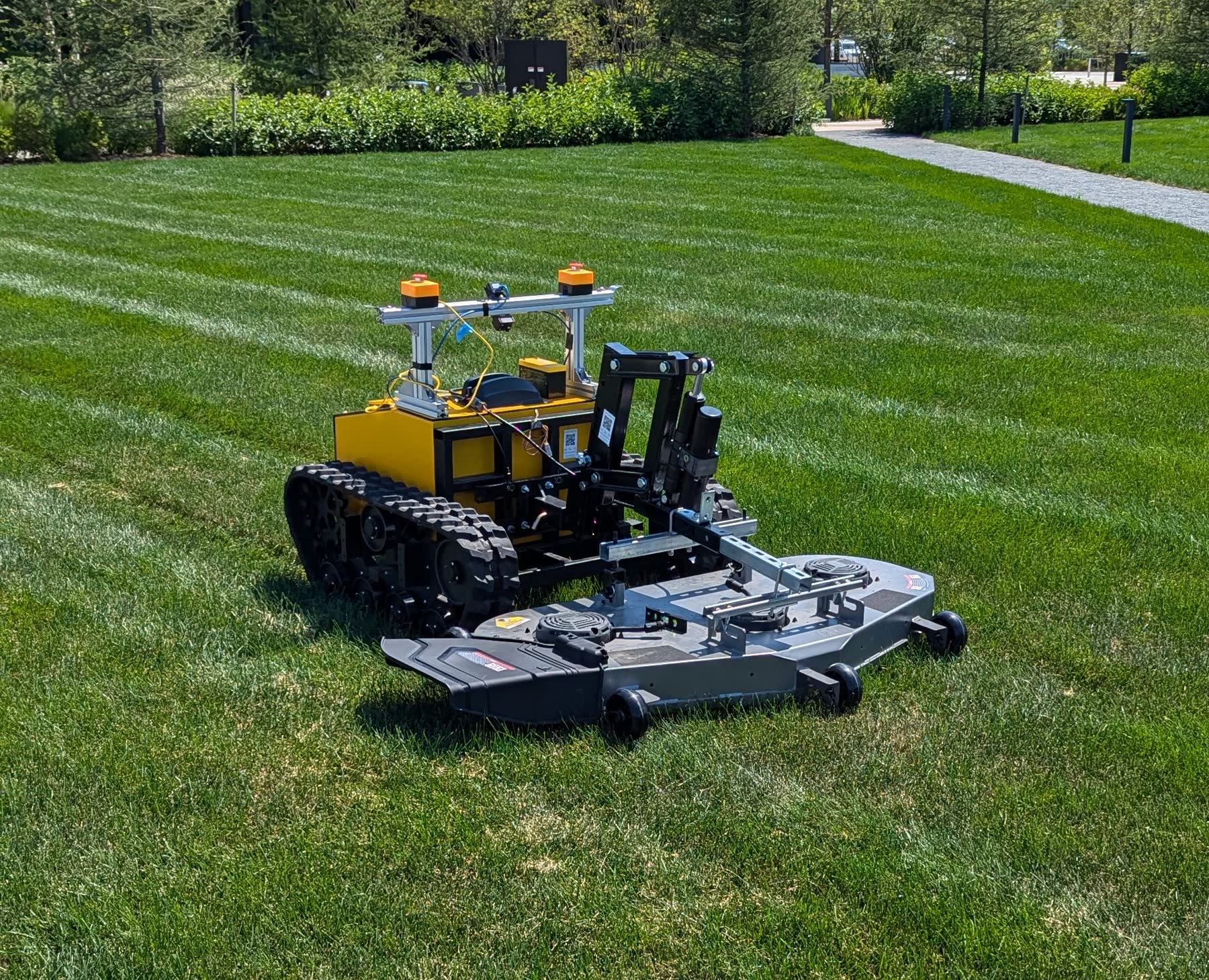 Snowbotix robot mowing commercial grass with precision navigation